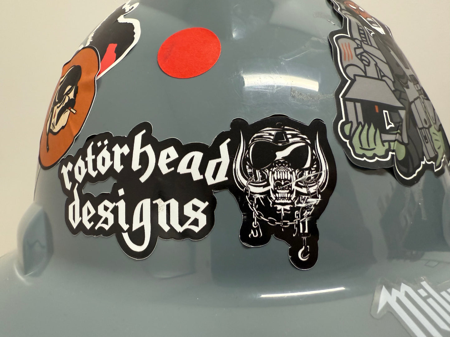 Helmet with various stickers including a prominent 'rotorhead designs' logo.